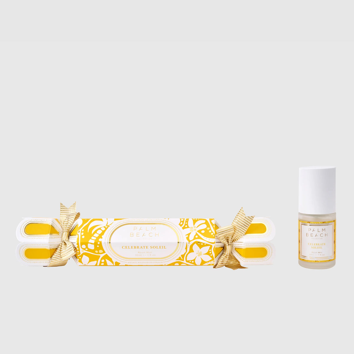 Decorative cracker and bottle with gold accents on a white background