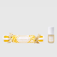 Decorative cracker and bottle with gold accents on a white background