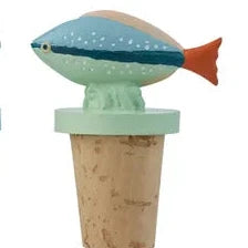 Set of four cork bottle stoppers with ocean-themed designs on a white background