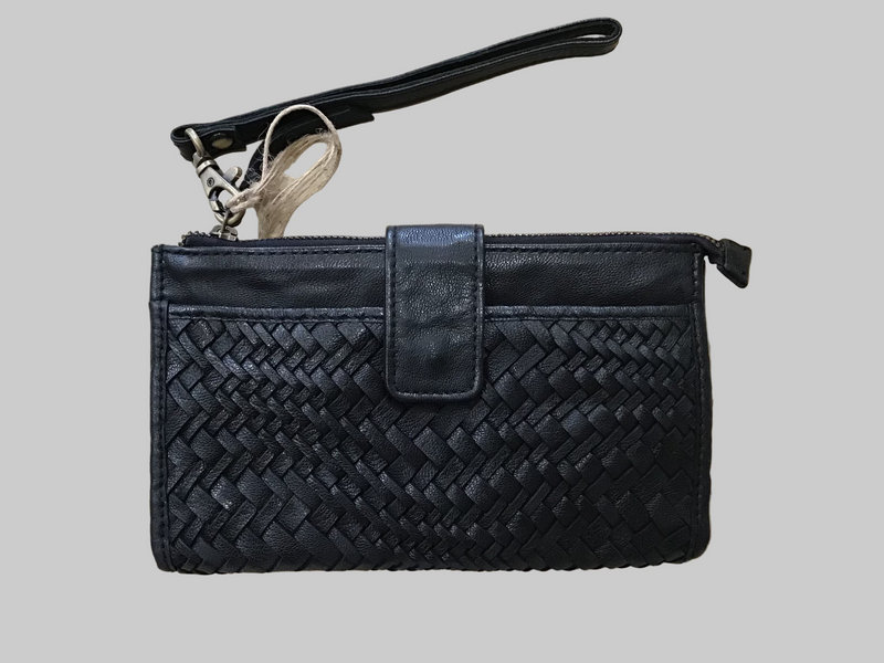Black woven clutch bag on a light wooden surface