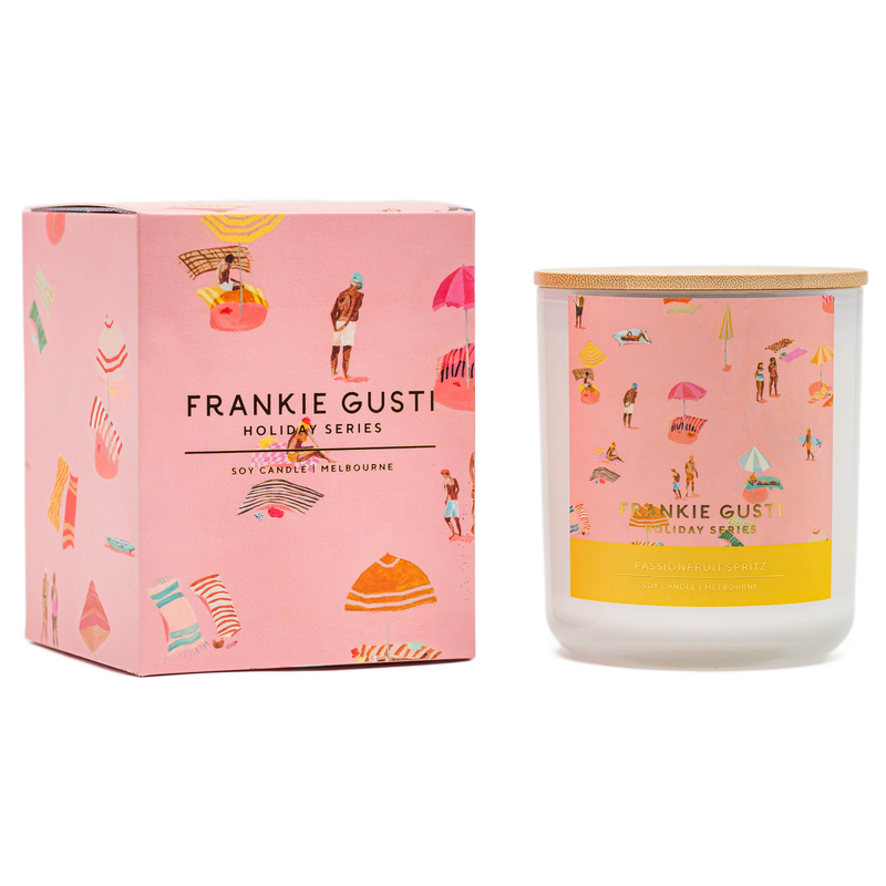 Frankie Gusti candle and packaging with holiday-themed illustrations on a white background
