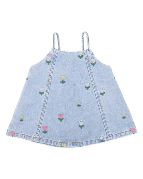 A light blue denim camisole top for toddlers, featuring thin shoulder straps, a V-neckline, and embroidered tulips in pink, yellow, and white with green leaves scattered across the front.