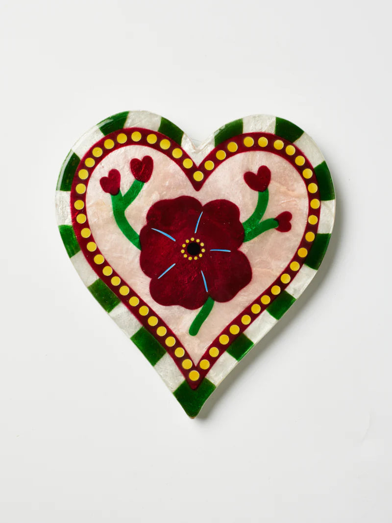 Decorative heart-shaped piece with floral design on a white background