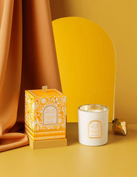 Candle and packaging on a yellow background