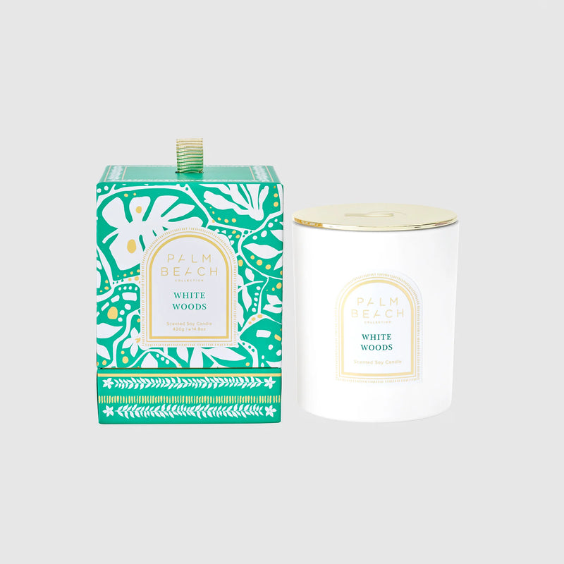 Candle and packaging with 'White Woods' label on a light gray background